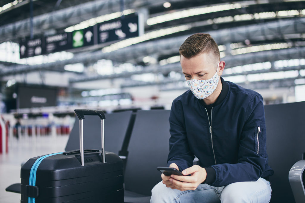 Image of traveler in airport with phone