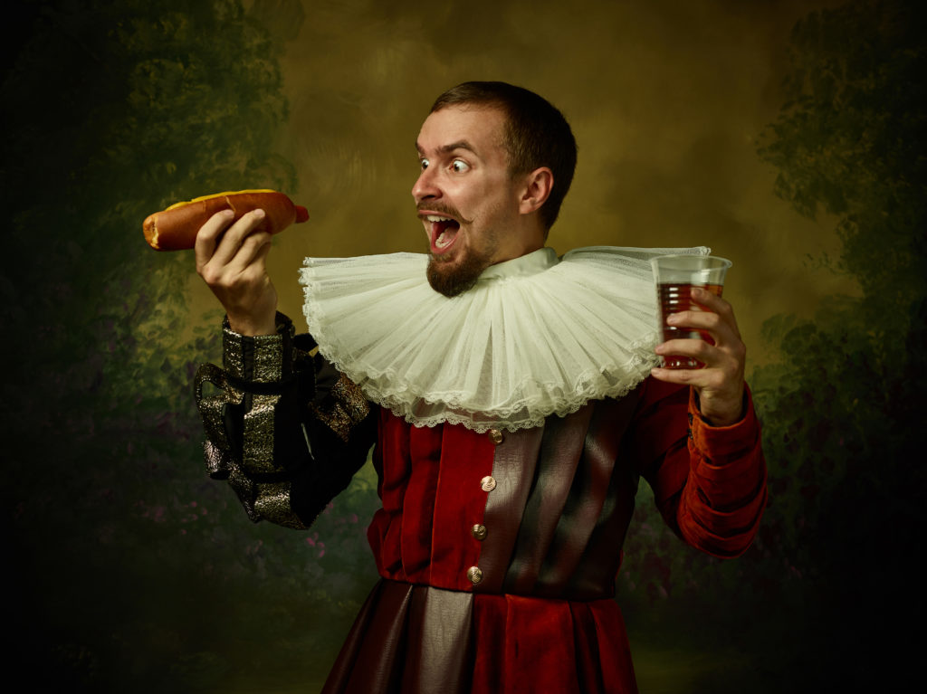 Guy in historical attire with hot dog