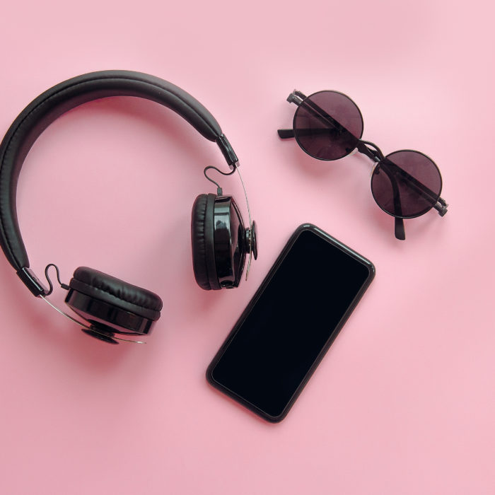 headphones, sunglasses, and a phone